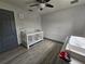 Bright Bedroom featuring a crib, changing table on a dresser, vinyl floors, and ceiling fan at 2235 Rabenton Rd, Deltona, FL 32738