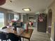 Kitchen area with gray cabinets, stainless steel appliances, a dining table, and gray wood-look floors at 2235 Rabenton Rd, Deltona, FL 32738