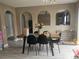 Kitchen area with gray cabinets, stainless steel appliances, a dining table, and gray wood-look floors at 2235 Rabenton Rd, Deltona, FL 32738