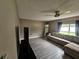 Living room featuring gray wood-look flooring, a ceiling fan, neutral walls and a beige sectional sofa at 2235 Rabenton Rd, Deltona, FL 32738