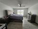A spacious main bedroom with a ceiling fan and luxury vinyl plank flooring at 2235 Rabenton Rd, Deltona, FL 32738