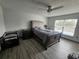 A spacious main bedroom with a ceiling fan and luxury vinyl plank flooring at 2235 Rabenton Rd, Deltona, FL 32738
