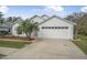 Charming single-story home with a two-car garage, well-maintained lawn, and inviting curb appeal at 232 Gala Cir, Daytona Beach, FL 32124