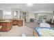 Open concept living and kitchen area featuring granite countertops and views to living room with vaulted ceiling at 232 Gala Cir, Daytona Beach, FL 32124