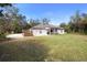 Large back yard with a patio and well-maintained lawn, ideal for entertaining at 239 Buena Vista St, Debary, FL 32713