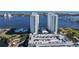 Aerial view of high-rise condos, parking garage, pools, landscaping, and waterfront access at 241 Riverside Dr # 1502, Daytona Beach, FL 32117