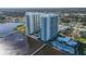 Aerial view of two modern high-rise condo towers on the water with lush landscaping and community pool at 241 Riverside Dr # 1502, Daytona Beach, FL 32117