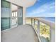 Spacious balcony featuring glass railings and panoramic views of the city and water at 241 Riverside Dr # 1502, Daytona Beach, FL 32117
