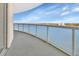 The balcony's glass railings offer unobstructed water views and a glimpse of the distant cityscape at 241 Riverside Dr # 1502, Daytona Beach, FL 32117