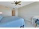 Bright bedroom with a ceiling fan, view to the bathroom, and light-colored floors at 241 Riverside Dr # 1502, Daytona Beach, FL 32117
