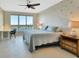 This bedroom features a bed, a desk, and a large window with gorgeous water views at 241 Riverside Dr # 1502, Daytona Beach, FL 32117