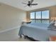 Cozy bedroom with water view, light colored floors, and a ceiling fan at 241 Riverside Dr # 1502, Daytona Beach, FL 32117