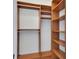 Well-organized closet with wooden shelving and hanging rods for optimal storage and organization at 241 Riverside Dr # 1502, Daytona Beach, FL 32117
