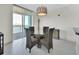 Open dining room featuring large windows with a water view, a round glass table and seating for four at 241 Riverside Dr # 1502, Daytona Beach, FL 32117