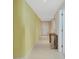 Bright hallway featuring tile flooring and light walls with view to apartment door at 241 Riverside Dr # 1502, Daytona Beach, FL 32117