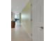 Inviting hallway with neutral walls and tile floors leading to the living area at 241 Riverside Dr # 1502, Daytona Beach, FL 32117