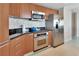 Modern kitchen with stainless steel appliances, granite countertops, and updated cabinetry at 241 Riverside Dr # 1502, Daytona Beach, FL 32117