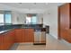 Well-lit kitchen with stainless steel appliances and dark countertops and a view to the ocean at 241 Riverside Dr # 1502, Daytona Beach, FL 32117