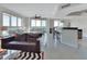 Bright, open-concept living room with tile floors, stylish furnishings, and views of the water at 241 Riverside Dr # 1502, Daytona Beach, FL 32117
