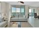 Serene living room with comfortable seating and sliding glass doors offering breathtaking water views at 241 Riverside Dr # 1502, Daytona Beach, FL 32117