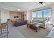 Spacious living room with a large window with views, stylish furniture, and modern decor at 241 Riverside Dr # 1502, Daytona Beach, FL 32117
