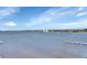 Enjoy expansive waterfront views with calm waters and a distant cityscape under a partly cloudy sky at 241 Riverside Dr # 1502, Daytona Beach, FL 32117