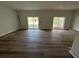 Spacious living room with new floors, bright lighting and sliding glass doors to a deck or patio at 283 Wildwood Dr, New Smyrna Beach, FL 32168