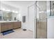 Modern bathroom featuring a glass shower, double vanity, and neutral tile at 291 Northcote Ct, Deland, FL 32724