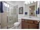 Bathroom with tiled walk-in shower, modern vanity, and decorative artwork at 291 Northcote Ct, Deland, FL 32724