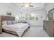 Cozy bedroom featuring a wooden bed frame, tray ceiling, and natural light from the window at 291 Northcote Ct, Deland, FL 32724