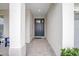 Covered entryway with brick flooring leading to a stylish front door, providing shelter and curb appeal at 291 Northcote Ct, Deland, FL 32724
