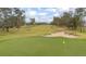 Scenic view of the golf course, showing meticulously maintained green and sand traps at 291 Northcote Ct, Deland, FL 32724