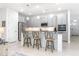 Modern kitchen with gray cabinets, granite countertops, stainless steel appliances, and counter seating at 291 Northcote Ct, Deland, FL 32724
