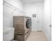 Modern laundry room with front load washer and dryer, and utility sink at 291 Northcote Ct, Deland, FL 32724