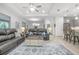 Open-concept living room with tile flooring, neutral decor, and seamless flow to the kitchen and dining areas at 291 Northcote Ct, Deland, FL 32724