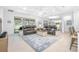 Spacious living room with leather sofas, tile flooring, and large windows overlooking the backyard at 291 Northcote Ct, Deland, FL 32724