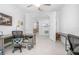 Bright office space with multiple desks and an open doorway leading to the kitchen at 291 Northcote Ct, Deland, FL 32724