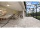Covered patio with dining table and chairs, hammock, and a screened-in enclosure at 291 Northcote Ct, Deland, FL 32724