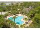 Aerial view of community pool area surrounded by lush tropical landscaping and palm trees at 291 Northcote Ct, Deland, FL 32724