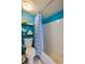Cozy bathroom with white tiled shower/tub and essential shelving at 313 S Atlantic Ave # 6140, Daytona Beach, FL 32118