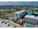 Aerial view of the complex with pools, tiki bar, and parking close to the beach at 313 S Atlantic Ave # 6140, Daytona Beach, FL 32118