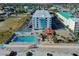 Aerial view of the complex with a tiki bar, parking, and a well-maintained pool at 313 S Atlantic Ave # 6140, Daytona Beach, FL 32118