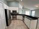 Well-lit kitchen with stainless steel appliances, white cabinets, and a breakfast bar at 3154 Red Berry Ct, Deltona, FL 32725