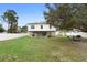 Expansive backyard featuring a white fence, covered patio, well-maintained lawn, and ample space for outdoor activities at 3318 Dewberry Dr, Deltona, FL 32738