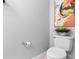 Powder room featuring a toilet, graphic art and small potted plant on tank at 3318 Dewberry Dr, Deltona, FL 32738