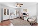 Cozy home office with wood floors, ceiling fan, and white storage cabinets, creating an organized workspace at 3318 Dewberry Dr, Deltona, FL 32738