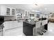 Modern kitchen featuring a kitchen island with bar seating, stylish countertops, white cabinets, and stainless steel appliances at 3318 Dewberry Dr, Deltona, FL 32738