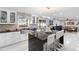 Modern kitchen featuring a kitchen island with bar seating, stylish countertops, white cabinets, and stainless steel appliances at 3318 Dewberry Dr, Deltona, FL 32738
