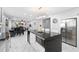 Open kitchen with a spacious island, modern appliances, and seamless flow into the dining and living areas at 3318 Dewberry Dr, Deltona, FL 32738