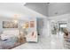 Bright living room showcasing a modern chandelier, a plush rug, and elegant decor complemented by marble floors at 3318 Dewberry Dr, Deltona, FL 32738